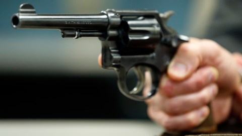 In this Wednesday, March 25, 2015, photo, Internal Revenue Service Special Agent In Charge Jonathan Larsen, holds a Smith & Wesson .38 Special during an interview in Mountainside, N.J. The gun belonged to IRS investigator Michael Malone, the man who went undercover to infiltrate Al Capones gang in the 1930s and eventually brought down the feared mobster. (AP Photo/Julio Cortez)