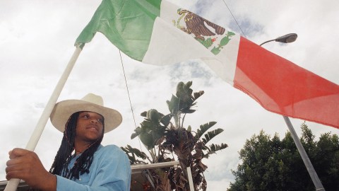 Nailah Akbar, 16, a member of the Queue Up Richland Farms Jr. Posse equestrian group from Compton, Calif., holds a Mexican flag while waiting to participate in a parade for ?Fiestas 16,? a three-day-event celebrating Mexican Independence Day in Los Angeles on Sunday, Sept. 14, 1997. (AP Photo/Seanna O?Sullivan)