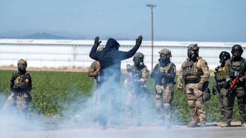 FILE - Federal immigration agents toss tear gas at protesters during a raid in the agriculture area of Camarillo, Calif., Thursday, July 10, 2025. (AP Photo/Michael Owen Baker, File)