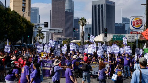 Union members and workers gather for a Labor Day rally in downtown Los Angeles on Monday, Sept. 4, 2017. Hundreds of people marched through downtown calling for a $15 minimum wage nationwide and stronger union protection for workers. The marchers held a large banner reading, "America Needs Unions" as they marched to City Hall while chanting. Some of the demonstrators also wore red shirts that said: "Fight for $15." Others walked with a large quilt created to signify unity for street vendors. (AP Photo/Richard Vogel)