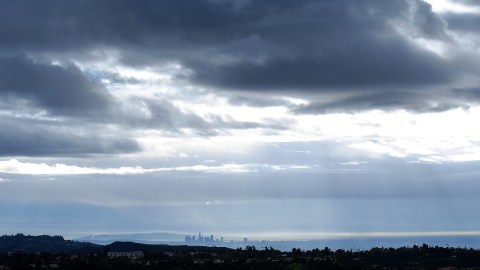 Dark and threatening storm clouds loom over downtown Los Angeles from a distant hilltop along the Santa Monica Mountains in the Encino area of Los Angeles, Sunday, March 1, 2015. A storm system over Southern California is expected to bring more snow, rain and possible thunderstorms to the region Sunday. The National Weather Service said the threat of showers will linger until Monday morning when the cold low-pressure system moves out. (AP Photo/Richard Vogel)