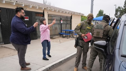 People film U.S. Border Patrol agents during an operation outside a Home Depot Friday, Aug. 15, 2025, in Los Angeles. (AP Photo/Gregory Bull)