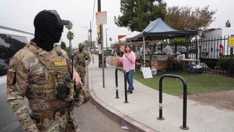 People film federal agents during an operation outside a Home Depot Friday, Aug. 15, 2025, in Los Angeles. (AP Photo/Gregory Bull)
