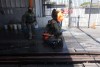 Immigration agents detain two men at a car wash on Friday, Aug. 15, 2025, in Montebello, Calif. (AP Photo/Gregory Bull)