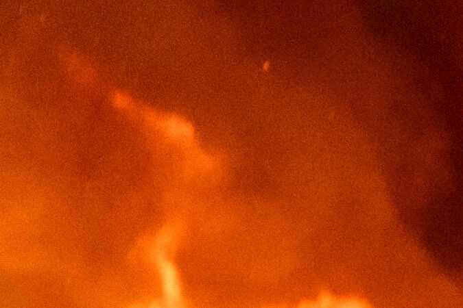 Layne Smith, left, clears vegetation to stop flames from spreading to his home as the 6-5 Fire burns through the Chinese Camp community of Tuolumne County, Calif., on Tuesday, Sept. 2, 2025. (AP Photo/Noah Berger)