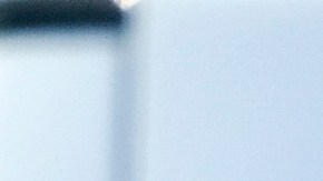 A neighbor, back left, stands behind a Los Angeles County Coroner vehicle parked near a home where five bodies were found in the city of Lancaster in the high desert Antelope Valley north of Los Angeles, Monday, Nov. 29, 2021. A Los Angeles County Sheriff's Department statement says deputies found a woman, a girl and three boys with gunshot wounds and paramedics pronounced them dead at the scene. The department says the children's father showed up at the Lancaster sheriff's station and was arrested on suspicion of five murders after being interviewed by detectives. (AP Photo/Ringo H.W. Chiu)