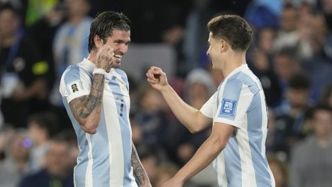 Argentina's Julian Alvarez, right, celebrates with teammate Rodrigo De Paul after scoring his side's opening goal against Brazil during a World Cup 2026 qualifying soccer match at Monumental Stadium in Buenos Aires, Argentina, Tuesday, March 25, 2025. (AP Photo/Gustavo Garello)