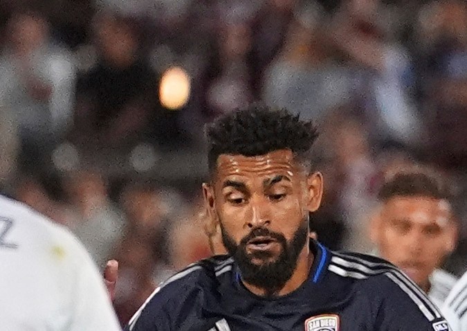 Colorado Rapids defender Reggie Cannon, center, pursues the ball while driving between San Diego FC midfielders Anibal Godoy, left, and Hirving Lozano, right, in the first half of an MLS soccer match Saturday, April 12, 2025, in Commerce City, Colo. (AP Photo/David Zalubowski)