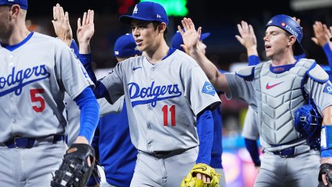 Los Angeles Dodgers relief pitcher Roki Sasaki high-fives teammates after the team's win in Game 2 of baseball's National League Division Series against the Philadelphia Phillies, Monday, Oct. 6, 2025, in Philadelphia. (AP Photo/Matt Rourke)