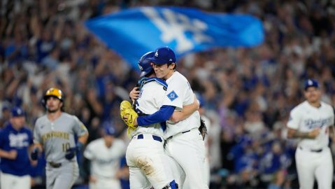 Los Angeles Dodgers pitcher Roki Sasaki and catcher Will Smith celebrates their win against the Milwaukee Brewers in Game 4 of baseball's National League Championship Series, Friday, Oct. 17, 2025, in Los Angeles. (AP Photo/Brynn Anderson)