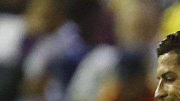 Real Madrid's Cristiano Ronaldo, left, walks past Liverpool's Steven Gerrard after Karim Benzema scored his side's third goal during the Champions League group B soccer match between Liverpool and Real Madrid at Anfield Stadium, Liverpool, England, Wednesday Oct. 22, 2014. (AP Photo/Jon Super)