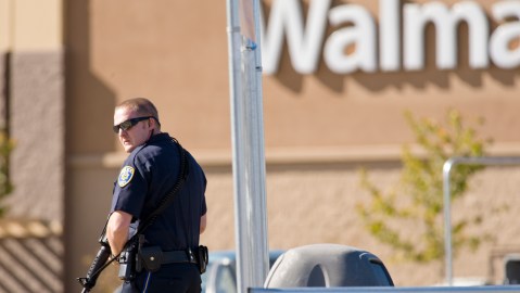 Reno police officers search through the parking lot during a standoff following a shooting at a Reno Walmart Friday, Oct. 29, 2010. The shooter, a Walmart employee, has been identified as John Dennis Gillane, 45-years of age. One of the three shooting victims was a store manager . (AP Photo/Scott Sady)
