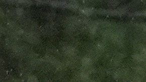 A worker clears debris from a road during a storm on Tuesday, Oct. 14, 2025, in Los Angeles. (AP Photo/Damian Dovarganes)