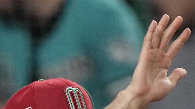 Teammates celebrate Mexico's Alex Verdugo (27) after he scored on a hit by Luis Urias to take a 5-4 lead against Puerto Rico during the seventh inning of a World Baseball Classic game, Friday, March 17, 2023, in Miami. Mexico defeated Puerto Rico 5-4. (AP Photo/Marta Lavandier)