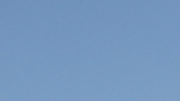 A helicopter flies a Mexican flag over the Hermanos Rodriguez racetrack prior to the start of the Formula One Mexico Grand Prix in Mexico City, Sunday, Oct. 26, 2025. (AP Photo/Eduardo Verdugo)
