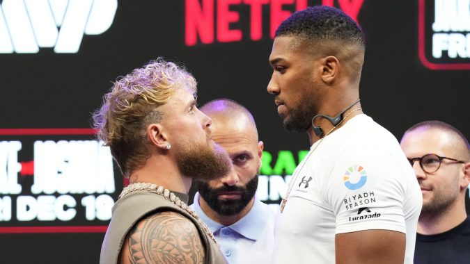 Jake Paul, left, and Anthony Joshua, right, face off during a news conference promoting their upcoming heavyweight boxing match, Friday, Nov. 21, 2025, in Miami. (AP Photo/Lynne Sladky)