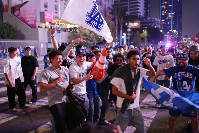 Fans celebrate in the streets in Los Angeles after the Los Angeles Dodgers defeated the Toronto Blue Jays in Game 7 of baseball's World Series Saturday, Nov. 1, 2025.(AP Photo/Ethan Swope)