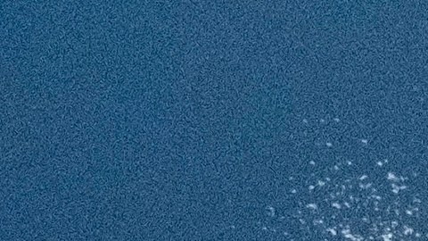 A beachgoer standing on a sand berm watches high surf near Manhattan Beach, Calif. on Thursday, Dec. 28, 2023. The National Weather Service has issued high surf warnings for much of the West Coast and parts of Hawaii, describing the waves and rip currents expected to hit certain coastlines as potentially dangerous and life-threatening.(AP Photo/Richard Vogel)