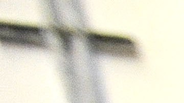 FILE - In this Nov. 14, 2013 file photo, a corrections officer stands near a gate at Baltimore City Detention Center in Baltimore. Inside the Baltimore City Detention Center, gang members used smuggled cellphones, dealt drugs and had sex with corrupt guards  several of whom they impregnated  who helped them as they ran operations of the Black Guerilla Family, according to court papers in a case alleging widespread corruption at the state-run facility. (AP Photo/Steve Ruark, FIle)