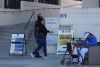 People arrive to vote for the statewide special election at the Orange County Registrar of Voters office in Santa Ana, Calif., on Wednesday, Oct. 29, 2025. (AP Photo/Damian Dovarganes)