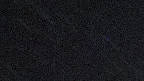 A homeless person walks under gusty showers in East Los Angeles early morning Tuesday, Oct. 14, 2025. (AP Photo/Damian Dovarganes)