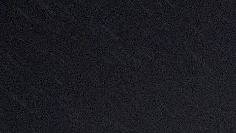 A homeless person walks under gusty showers in East Los Angeles early morning Tuesday, Oct. 14, 2025. (AP Photo/Damian Dovarganes)