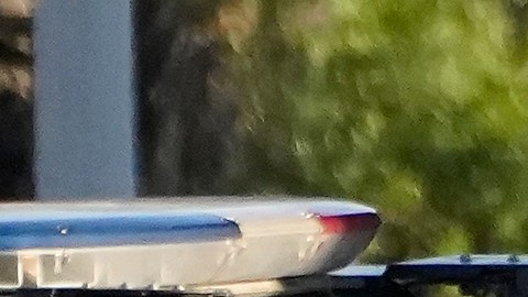 A Los Angeles Police officer and members of the Office of the Mayor of Los Angeles assist witnesses after two people were killed Tuesday, Aug. 2, 2022 in Los Angeles. Authorities say a driver who was fleeing police crashed into a homeless encampment in South Los Angeles, killing a man and a woman. (AP Photo/Damian Dovarganes)