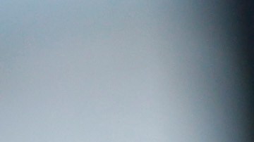 A handcuffed suspect waits inside a police bus during an operation against alleged drug traffickers at the Complexo do Alemao slum in Rio de Janeiro, Brazil, Saturday, Nov. 27, 2010. Soldiers and police crouching behind armored vehicles trained their rifles on dozens of entrances to a sprawling slum Saturday, preparing to invade and try to push drug gangs out an area long considered the most dangerous in Rio de Janeiro, a city set to host the 2016 Olympics. (AP Photo/Felipe Dana)