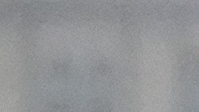 A commuter walks under heavy rain in downtown Los Angeles, Monday, Nov. 17, 2025. (AP Photo/Damian Dovarganes)