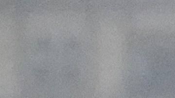 A commuter walks under heavy rain in downtown Los Angeles, Monday, Nov. 17, 2025. (AP Photo/Damian Dovarganes)