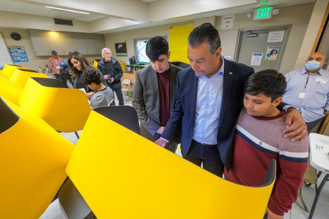 California State Sen. Alex Padilla, second from right, with his wife Angela, left, and sons Roman, center, Diego, right, and Alex Jr. second from left, cast their ballots at a voting station, Tuesday, Nov. 8, 2022, in Pacoima, Calif. (AP Photo/Ringo H.W. Chiu)