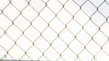 FILE - In this Dec. 16, 2015, file photo, Los Angeles School Police Department officer Alex Camarillo, left, and an administrator welcome students heading back to school at the Edward R. Roybal Learning Center in Los Angeles a day after an emailed threat triggered a shutdown of all Los Angeles Unified School District campuses. Demonstrators outside the the school board headquarters demanded the defunding of the Los Angeles school district police, Tuesday, June 23, 2020, in Los Angeles. (AP Photo/Damian Dovarganes, File)