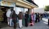 Customers wait in line at the Blue Bird Liquor Store to buy Powerball lottery tickets in Hawthorne, Calif. on Friday, Jan. 8, 2016. Lottery officials confirmed Friday that Saturday nights drawing will be for a record $800 million. The ever-increasing jackpot is a result of strong national sales ever since the jackpot was near $400 million just days ago. (AP Photo/Nick Ut)
