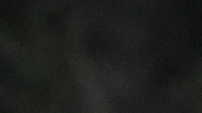 Aundre Smith, left, watches as Genesis Smith places flowers near the scene of a mass shooting on Saturday at a banquet hall in Stockton, Calif., Monday, Dec. 1, 2025. (AP Photo/Jeff Chiu)