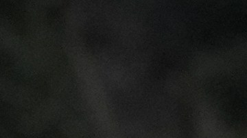 Aundre Smith, left, watches as Genesis Smith places flowers near the scene of a mass shooting on Saturday at a banquet hall in Stockton, Calif., Monday, Dec. 1, 2025. (AP Photo/Jeff Chiu)