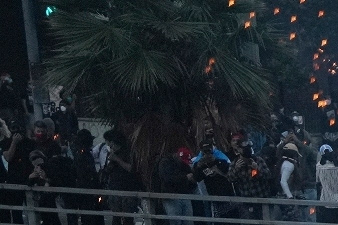 EDS NOTE: OBSCENITY A flash bomb explodes on the 101 Freeway near the metropolitan detention center of downtown Los Angeles, June 8, 2025, following an immigration raid protest the night before. (AP Photo/Eric Thayer, File)