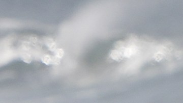 A surfer enters the water after a rainstorm at Cardiff State Beach Friday, Nov. 21, 2025, in Solana Beach, Calif. (AP Photo/Gregory Bull)