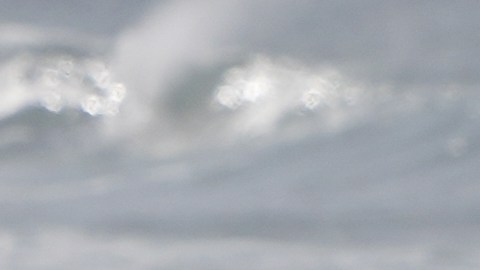 A surfer enters the water after a rainstorm at Cardiff State Beach Friday, Nov. 21, 2025, in Solana Beach, Calif. (AP Photo/Gregory Bull)