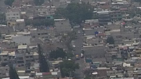 Pollution blankets the sky over the iconic Estadio Azteca and the rest of Mexico City, Thursday, May 16, 2019. A semifinal match between America and Leon that had already been postponed due to air quality will be played out of the city in Queretaro on Thursday. (AP Photo/Rebecca Blackwell)