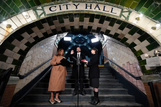 Zohran Mamdani (center) is sworn in as mayor of New York City before prosecutor Letitia James (left) accompanied by his wife Rama Duwaji (right). The event was held at the Old City Hall subway station.