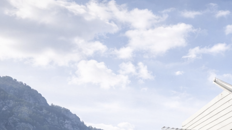 Vivienda futurista elevada del suelo mediante tecnología antisísmica, ubicada en un entorno montañoso.