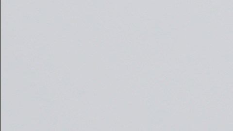 FILE - Barbed wire fencing is shown behind a sign in English and Spanish in a recreation yard used by detainees during a media tour of the U.S. Immigration and Customs Enforcement detention center, Dec. 16, 2019, in Tacoma, Wash. (AP Photo/Ted S. Warren, file)