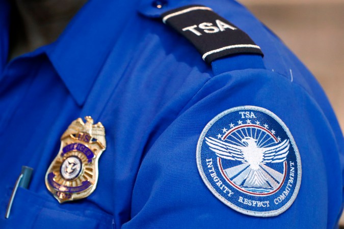 FILE - A Transportation Security Administration officer works at Dallas Love Field Airport on June 24, 2020, in Dallas. A man was arrested Monday, Feb. 27, 2023, after an explosive was found in a bag checked onto a Florida-bound flight at Lehigh Valley International Airport in Allentown, Pa., federal authorities said. (AP Photo/Tony Gutierrez, File)