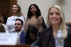 La fiscal Pam Bondi testifica ante una audiencia de supervisión del Comité Judicial de la Cámara, a la izquierda algunas víctimas de Epstein.