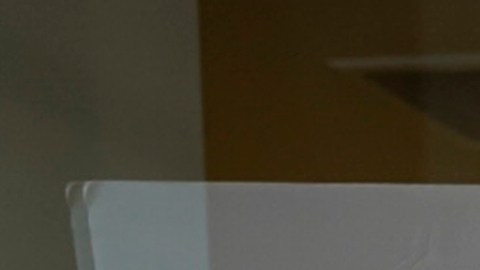 FILE - A protester, demonstrating against COVID-19 vaccine mandates, holds a sign outside the front windows of the Los Angeles Unified School District, LAUSD headquarters in Los Angeles, Sept. 9, 2021. The Los Angeles public school system became the latest in California to delay a deadline for mandatory student COVID-19 vaccinations. The board of the Los Angeles Unified School District voted Tuesday night, Dec. 14 to postpone a Jan. 10 deadline until fall 2022 for all students 12 and older to be vaccinated. (AP Photo/Damian Dovarganes, File)