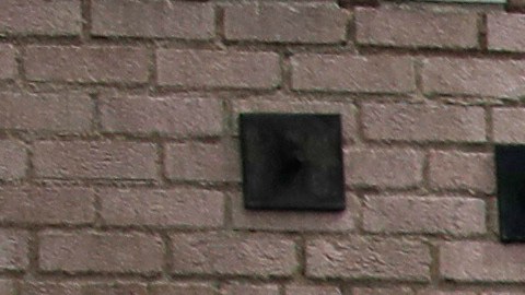 FILE - In this March 20, 2020 file photo a man covers his face with a mask as he walks past tents on skid row, in Los Angeles. A fed-up federal judge says last week's rainstorm created "extraordinarily harsh" conditions for homeless residents of Los Angeles and he has ordered city officials to meet with him this week at a Skid Row shelter to discuss how to address the worsening crisis of people living on the streets. (AP Photo/Marcio Jose Sanchez,File)