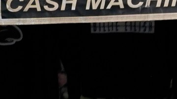 A business covers merchandise from the rain with a plastic bags in the Chinatown district of Los Angeles, Monday, Nov. 7, 2022. A new Pacific storm is bringing snow, rain and wind to California. (AP Photo/Damian Dovarganes)