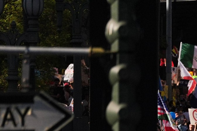 People march carrying signs and flags during a protest in Los Angeles on Friday, Jan. 30,2026. (AP Photo/Jae C. Hong)