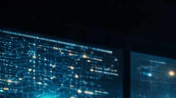 Entorno tecnológico con múltiples pantallas y visualizaciones de inteligencia artificial en un ambiente oscuro y futurista.