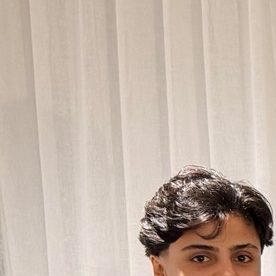 In this photo supplied by Australia's Minister for Home Affairs Tony Burke's office, the Minister Tony Burke, center, poses in an undisclosed location with five Iranian women soccer players who have been granted asylum in Australia, Tuesday, March 10, 2026. (Australia Ministry of Home Affairs via AP)